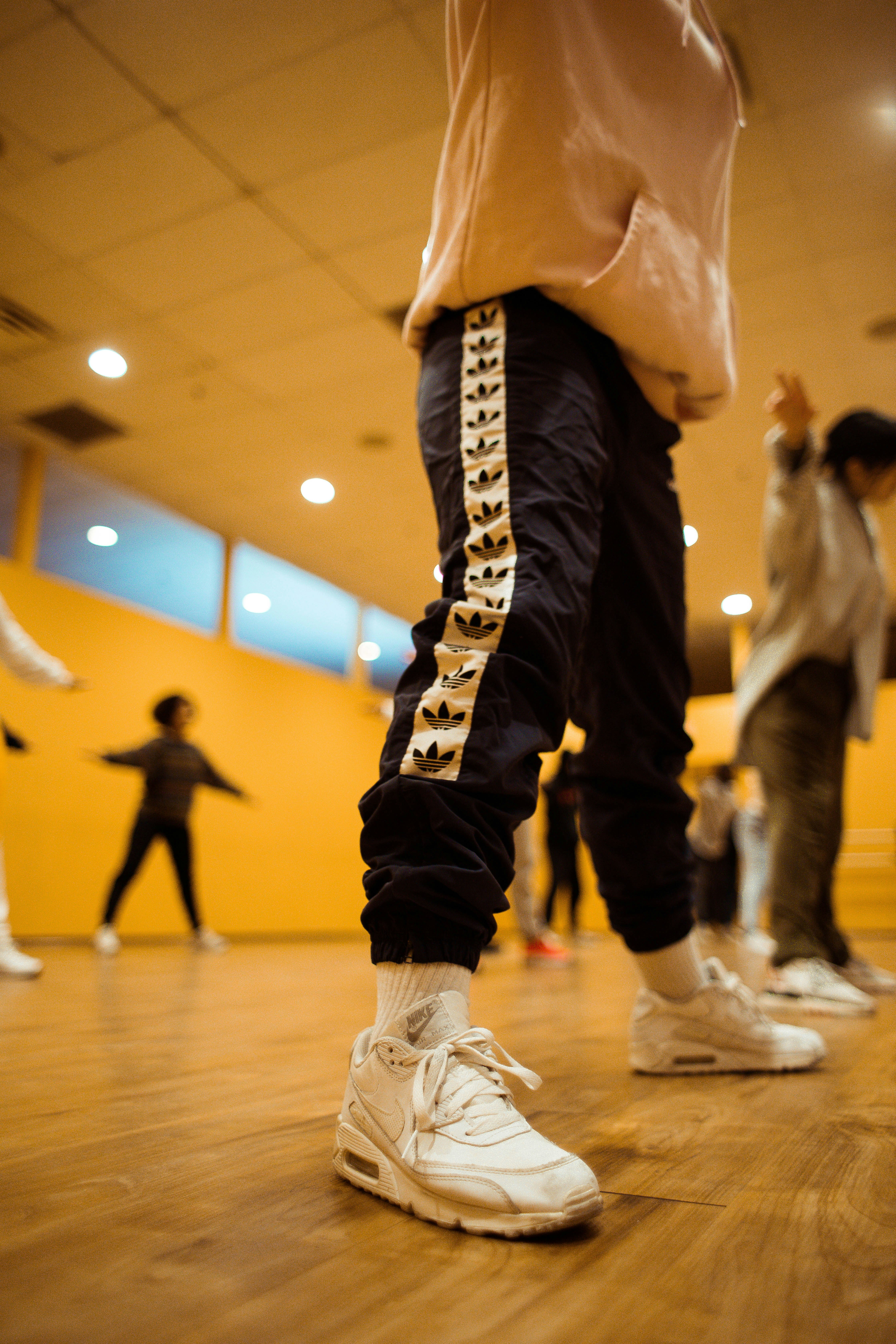Children practicing different dance styles in a studio